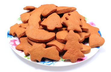 Fresh baked homemade Christmas cookies on plate. White background