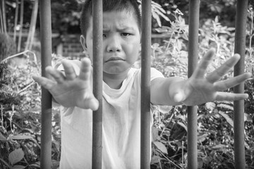 Fototapeta premium Young homeless Asian boy scared and alone, he is at high risk of being abused and trafficked