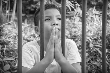 Obraz premium Young homeless Asian boy scared and alone, he is at high risk of being abused and trafficked