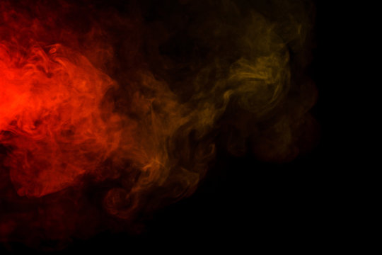 Abstract red and yellow smoke hookah on a black background.