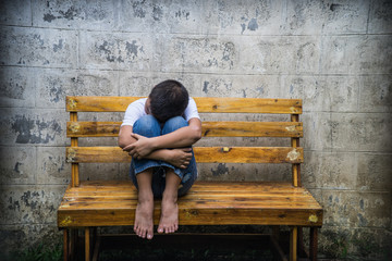 Young Asian homeless boy scared and alone, he is at high risk of being physically abused and...