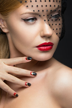 Beautiful girl with a veil, evening makeup, black and red nails