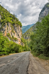 Asphalt road by mountain gorge