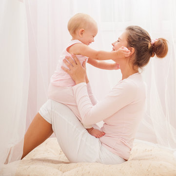 Mother and baby playing and smiling. Happy family.Home interior.