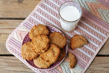 Homemade cookies and glass of milk on table close up