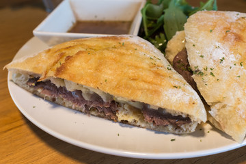 Roast beef sandwich dish with rocket salad