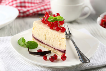 Delicious cheesecake with berries on table close up