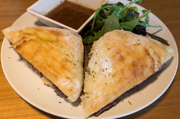 Roast beef sandwich dish with rocket salad