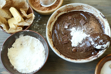 Preparing dough for chocolate pie on table close up