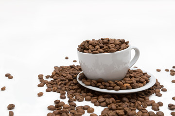 Coffee beans in coffee cup isolated on white