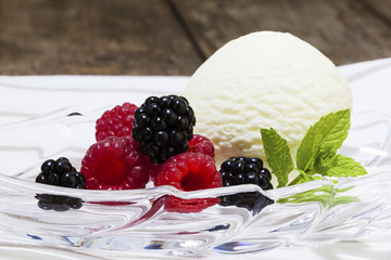 Vanilla ice cream scoop, raspberries and blackberries