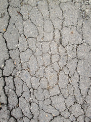 Old worn and cracked asphalt with cracks
