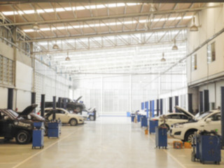 Blurred background : Car technician repairing the car in garage 