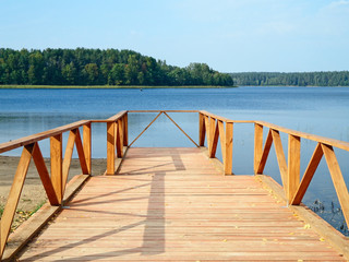 Wooden footbridge on the shore of the lake