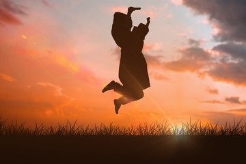 Composite image of happy male student in graduate robe jumping