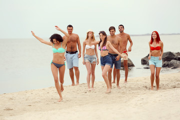 Beautiful young people having fun on beach