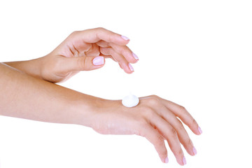 Beautiful women hands applying cream isolated on white