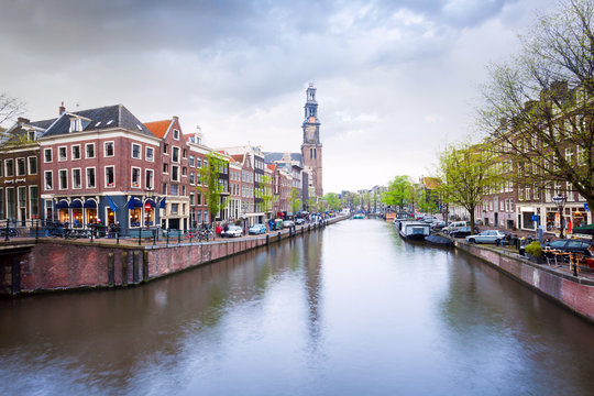 Beautiful view of Amstel river and houses facades
