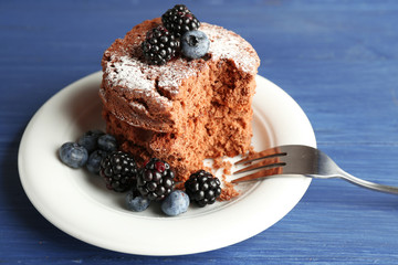 Cake with berries on wooden table