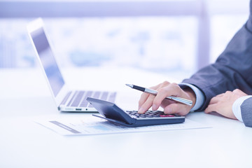 Businessman analyzing investment charts with laptop. Accounting