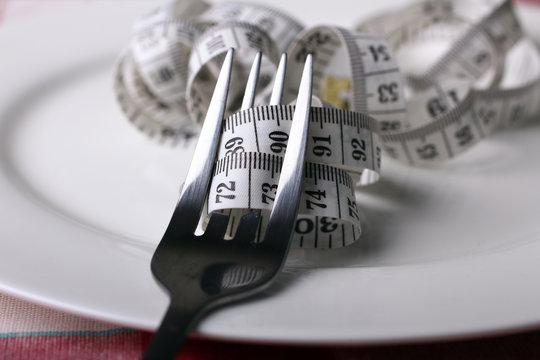 fork and measuring tape on a plate