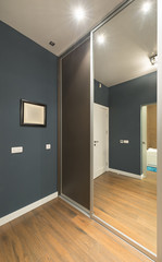 Wardrobe interior with large mirror door