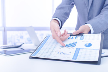 Businessman analyzing investment charts. Accounting