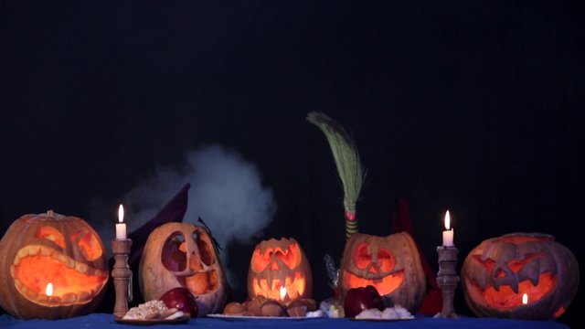 Two Little Witches Doing Magic Over Pumpkins At Halloween