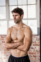 Obraz premium Shirtless man with arms crossed