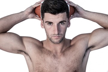 Fototapeta premium Portrait of a man holding ball over his head