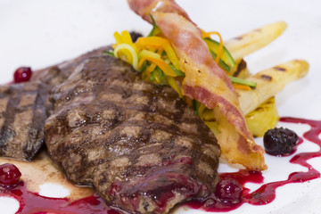 steak with asparagus and salad on a white background in restaurant
