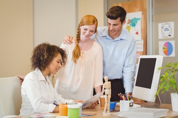 Businesswoman showing documents to colleagues 