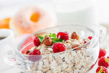 Oatmeal breakfast with coffee, muesli with fruits and nuts.