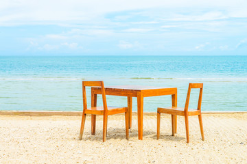 Wooden table and chair for dinner on the beach