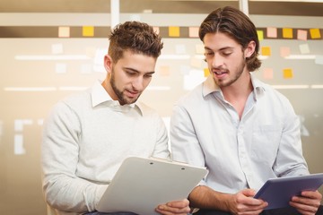 Obraz premium Businessmen with digital tablet and document