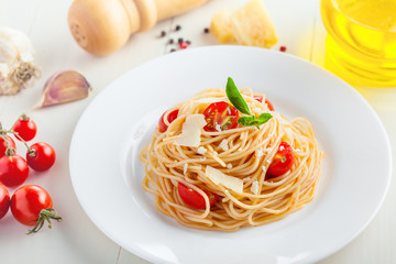 Pasta in tomato sauce with parmesan cheese and basil