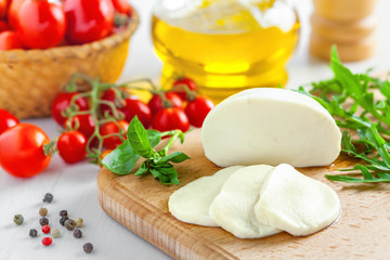 Mozzarella with tomatoes and arugula, caprese salad cooking