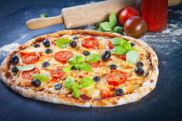 Closeup hand of baker making pizza at kitchen