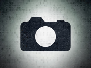 Tourism concept: Photo Camera on Digital Paper background