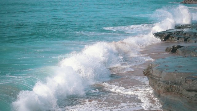 Slow motion Ocean Waves Breaking on Shore, closeup
