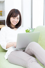 young asian woman using laptop