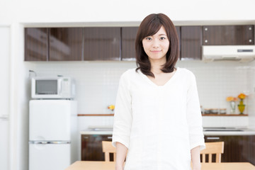 young asian woman relaxing in the kitchen