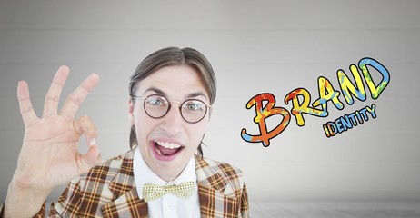 Obraz premium Composite image of geeky hipster doing the ok sign