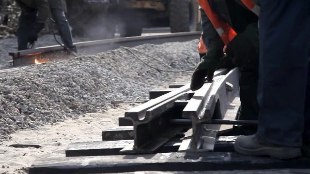 Railway workers bolting track rail 