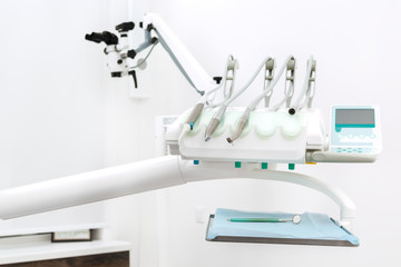 Dental instruments and microscope on background
