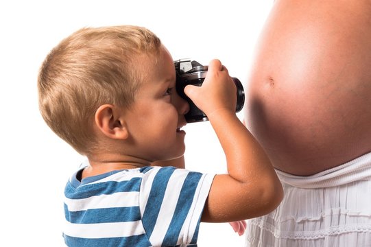 Kid photographing his pregnant mother
