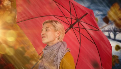 Composite image of happy woman keeping dry