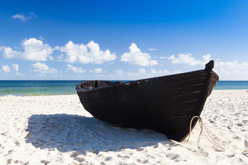 Black fishing boat on the beach on Ruegen Island, Germany