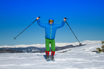 Fototapeta na wymiar Winter hiking in the mountains on snowshoes with a backpack and tent.