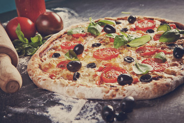 Home made raw pizza with prosciutto and blue cheese. The dough w